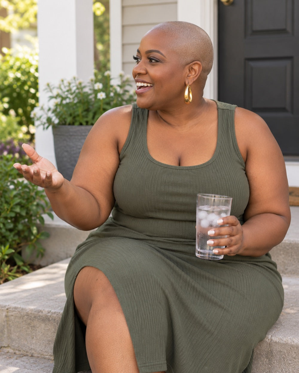 A woman chatting with a friend on her front porch